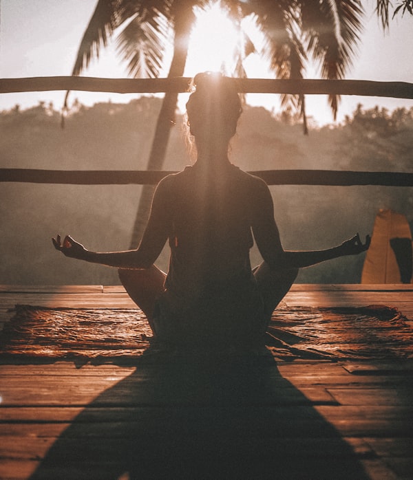 Person meditating or practicing mindfulness in a serene environment