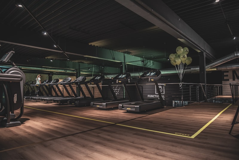Shaker bottle and sport shoes on gym floor